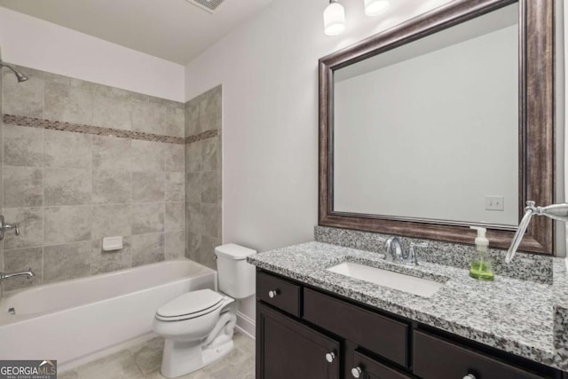 full bathroom with toilet, tiled shower / bath, vanity, and tile patterned floors