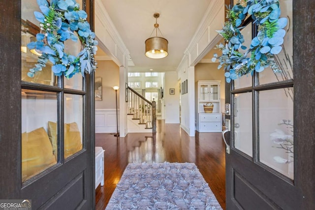 entryway featuring dark wood-type flooring and ornamental molding