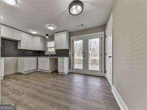 kitchen featuring french doors, a wealth of natural light, and white cabinetry