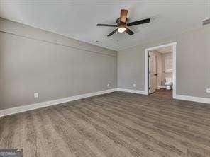 interior space featuring ceiling fan and dark hardwood / wood-style floors