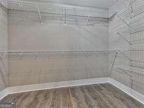 walk in closet with wood-type flooring