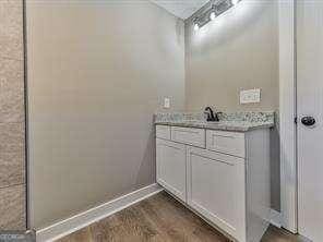 bathroom with vanity and hardwood / wood-style flooring