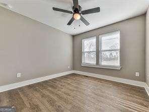 spare room with ceiling fan and hardwood / wood-style flooring