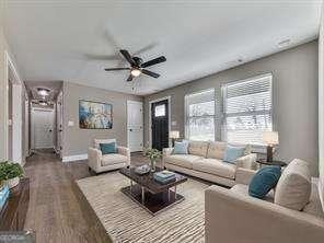 living room featuring ceiling fan and hardwood / wood-style flooring