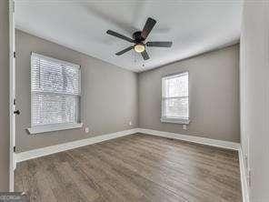 unfurnished room featuring ceiling fan and hardwood / wood-style flooring