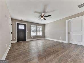 foyer entrance featuring ceiling fan and dark hardwood / wood-style floors