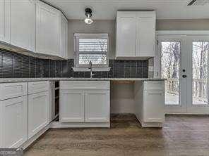 kitchen with a healthy amount of sunlight, white cabinetry, and decorative backsplash