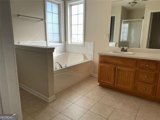 bathroom featuring tile patterned flooring, vanity, and separate shower and tub