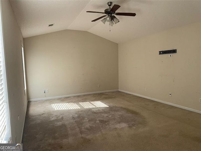 carpeted empty room featuring lofted ceiling, a textured ceiling, and ceiling fan