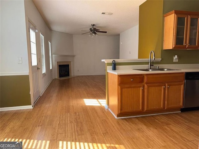 kitchen featuring sink, light hardwood / wood-style flooring, dishwasher, and ceiling fan