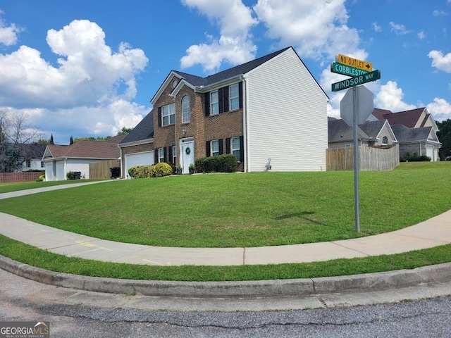 view of front of home featuring a garage and a front yard