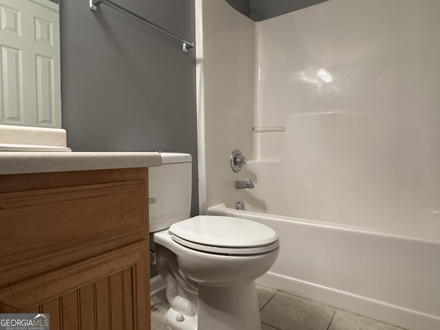 full bathroom with tile patterned flooring, vanity,  shower combination, and toilet