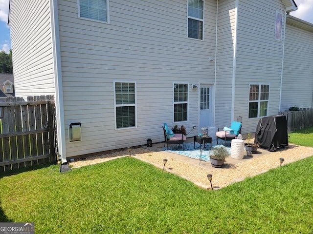 rear view of house featuring a yard and a patio area