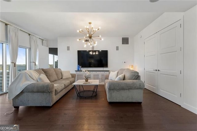 living room featuring dark hardwood / wood-style flooring and a notable chandelier