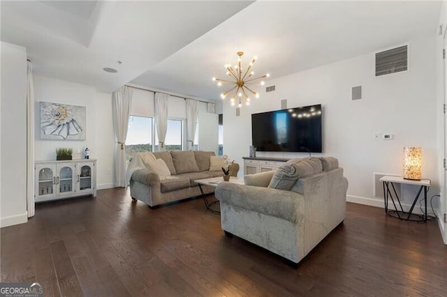 living room featuring dark hardwood / wood-style flooring and a chandelier