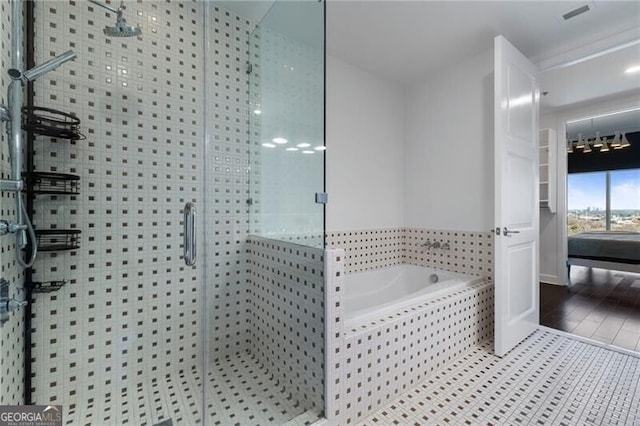 bathroom featuring independent shower and bath