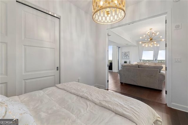 bedroom featuring dark hardwood / wood-style floors and a chandelier