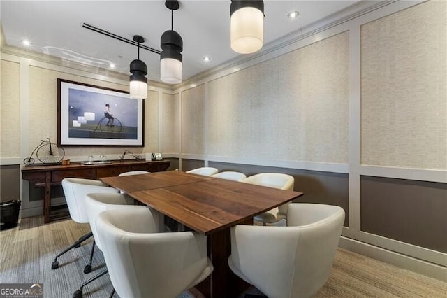 dining room with light colored carpet and ornamental molding