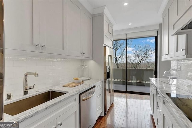 kitchen featuring stainless steel appliances and white cabinetry