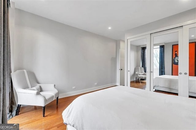 bedroom with hardwood / wood-style flooring and french doors