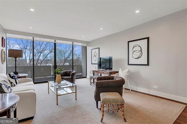 living room with floor to ceiling windows and light wood-type flooring