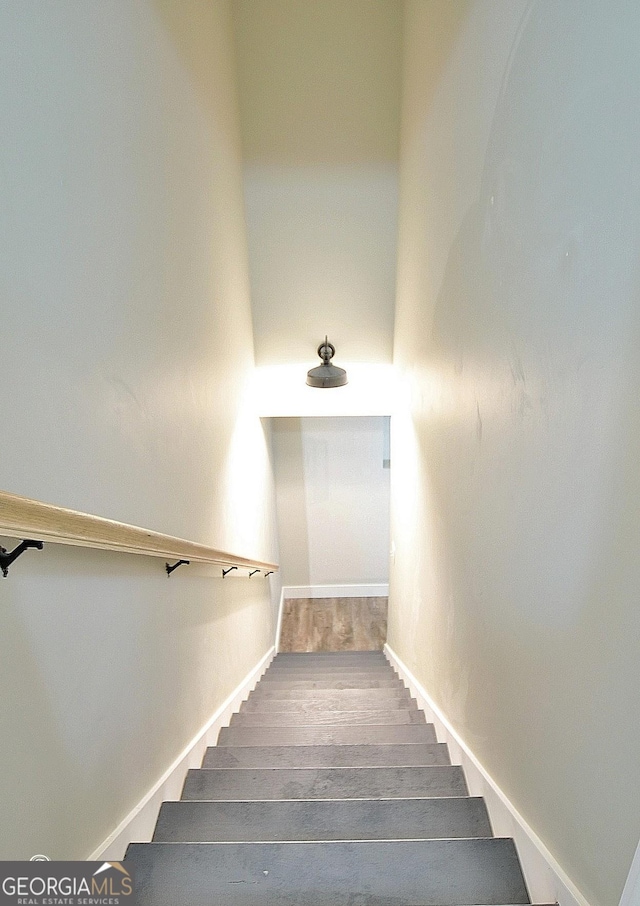 staircase featuring hardwood / wood-style floors