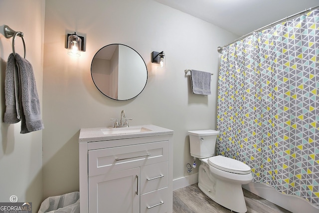 bathroom featuring hardwood / wood-style flooring, vanity, and toilet