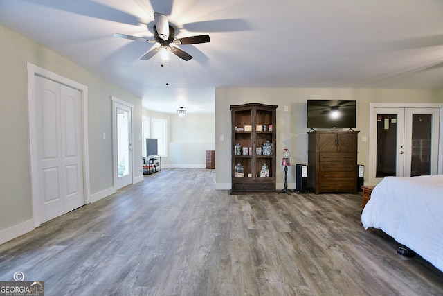 unfurnished bedroom with wood-type flooring, french doors, and ceiling fan