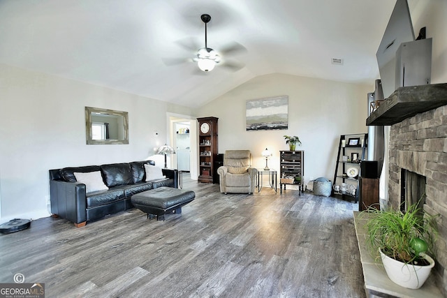 living room with hardwood / wood-style flooring, ceiling fan, lofted ceiling, and a fireplace