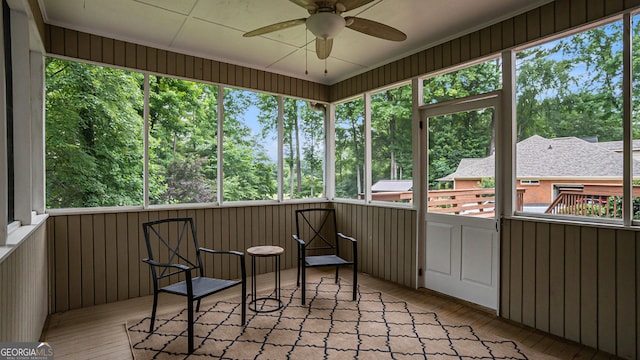 sunroom featuring ceiling fan