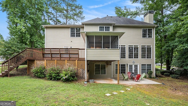 rear view of property with a sunroom, a yard, french doors, a deck, and a patio