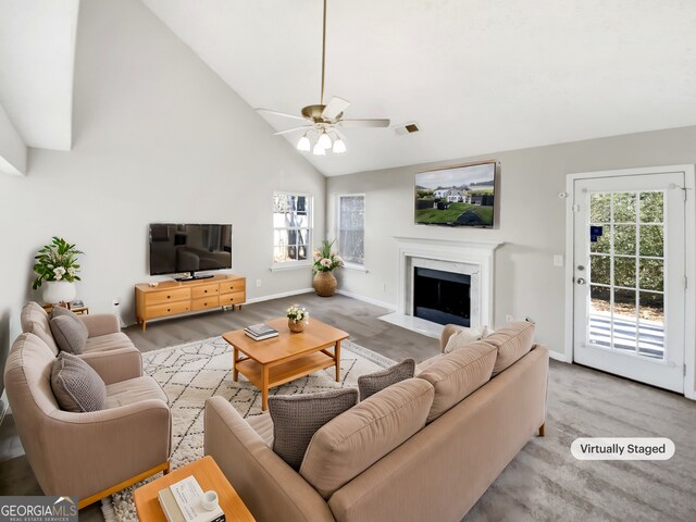 living room with ceiling fan, a fireplace, and high vaulted ceiling