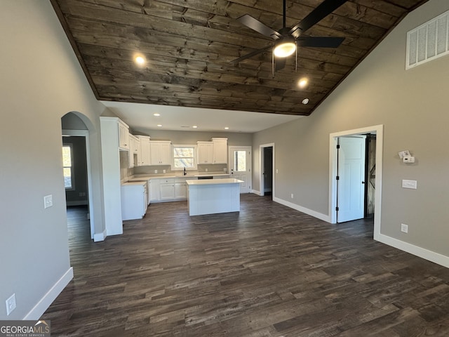 kitchen featuring a center island, wood ceiling, dark wood-type flooring, white cabinetry, and high vaulted ceiling