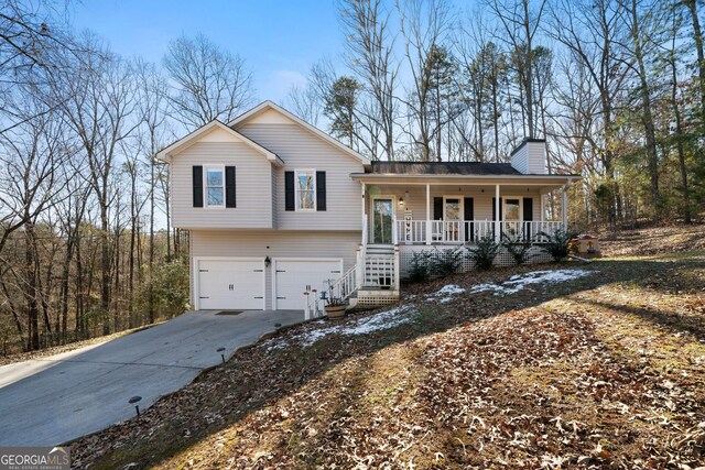 split level home with covered porch and a garage