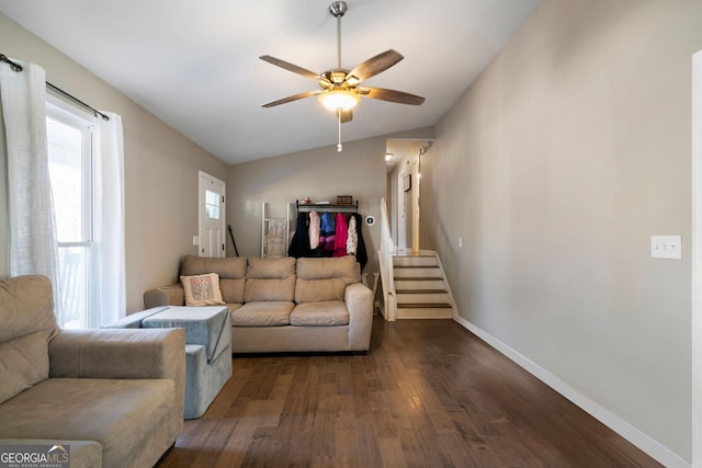 living room featuring baseboards, stairs, dark wood-type flooring, lofted ceiling, and a ceiling fan