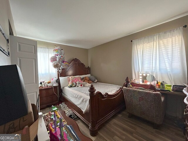 bedroom featuring dark hardwood / wood-style floors and multiple windows