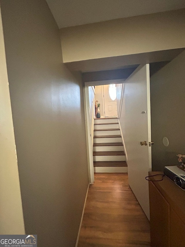 corridor with hardwood / wood-style floors