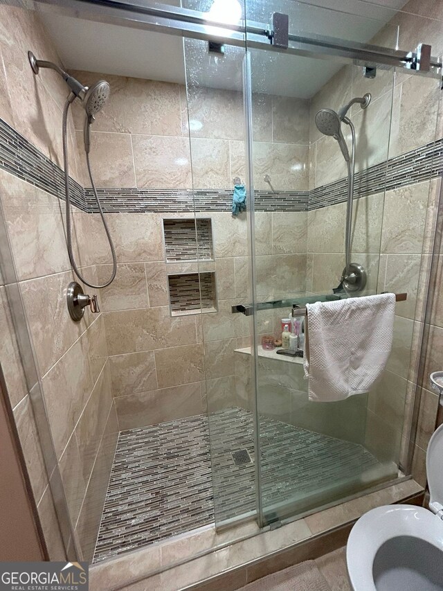 bathroom featuring a shower with shower door