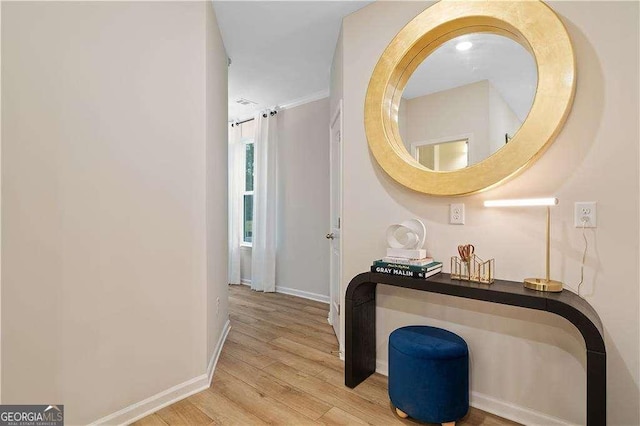 hall featuring wood finished floors and baseboards