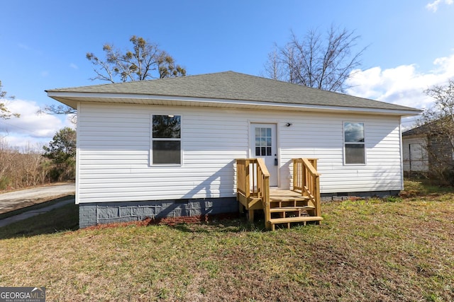 rear view of property featuring a yard