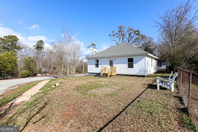 back of house with a lawn