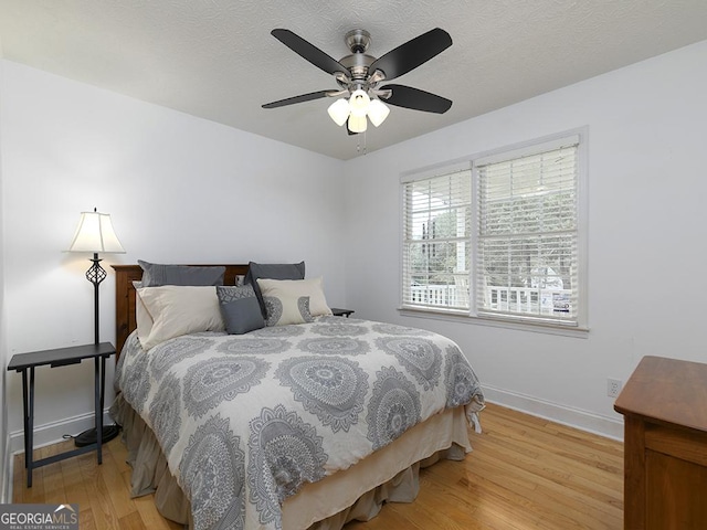 bedroom with ceiling fan and light hardwood / wood-style floors