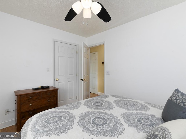 bedroom with ceiling fan and light hardwood / wood-style floors