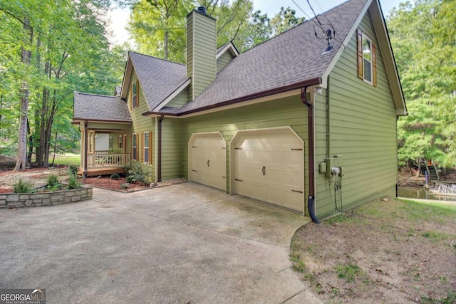 view of home's exterior with a garage and a porch