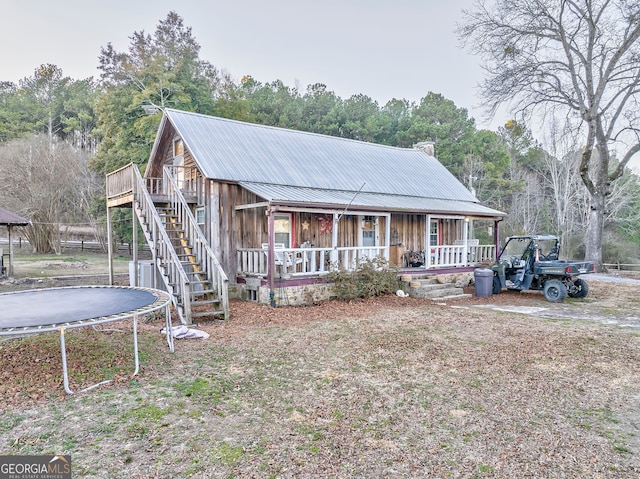 view of front of house featuring a trampoline and a porch