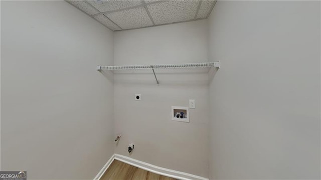 clothes washing area with gas dryer hookup, electric dryer hookup, hardwood / wood-style flooring, and washer hookup