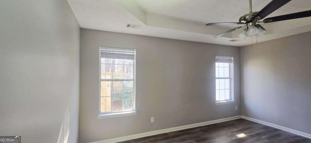 unfurnished room with ceiling fan and dark hardwood / wood-style flooring