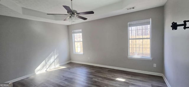 empty room featuring dark wood-type flooring and ceiling fan