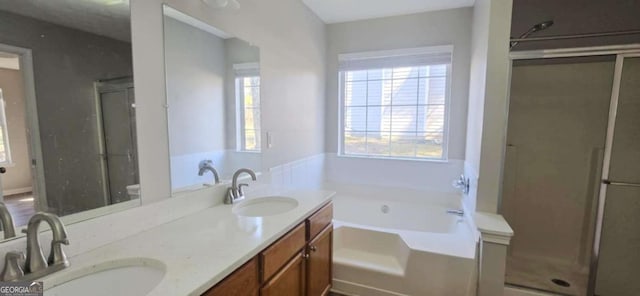 bathroom featuring independent shower and bath and vanity