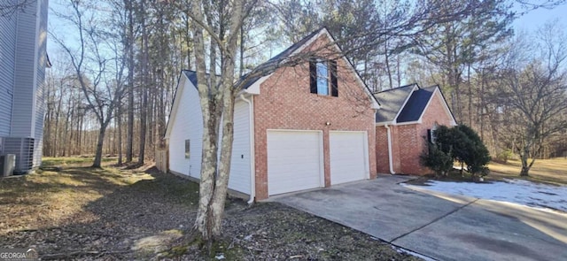 view of property exterior with a garage and central air condition unit